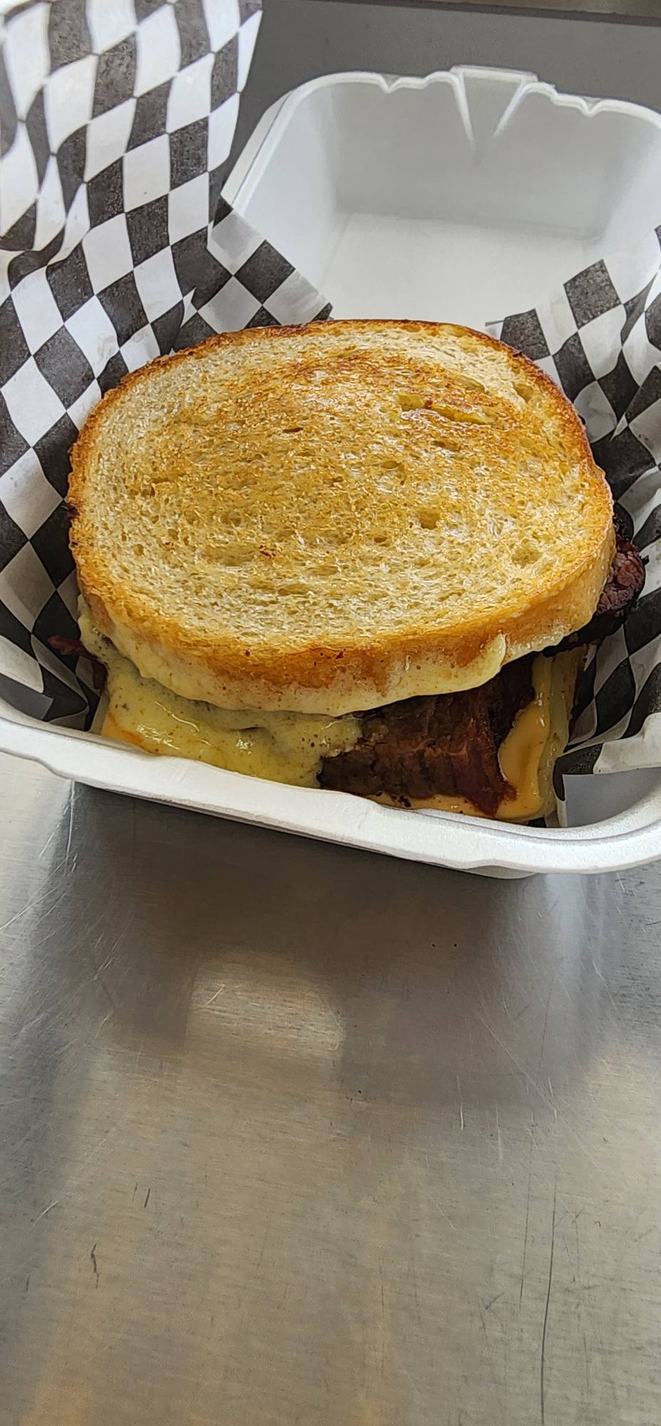 A grilled brisket melt boxed and ready