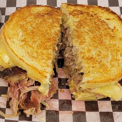 Pulled pork melt sandwich, split and stacked